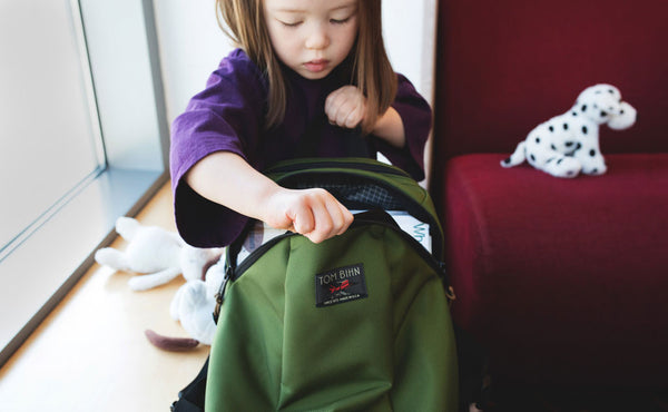 A child accessing the main compartment of The Sprout.